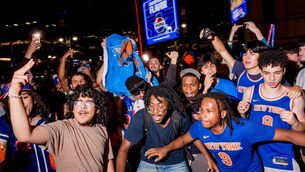 <p>Fans celebrate after the New York Knicks win Game 1 of the NBA Finals against San Antonio Spurs outside of Madison Square Garden. Pic: Adam Gray/Getty Images</p>