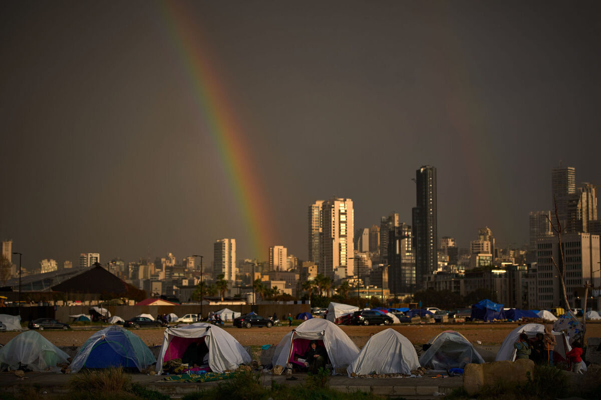 Displaced people who fled Israeli strikes in southern Lebanon sit inside tents. Picture: AP Photo/Emilio Morenatti