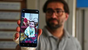 <p>Fahd Abu Haikal shows a photo of his seven-month- old son, Sam, who was killed on Friday when Israeli soldiers fired at their car. Picture: Mahmoud Illean/AP</p> <p>Fahd Abu Haikal shows a photo of his seven-month- old son, Sam, who was killed on Friday when Israeli soldiers fired at their car. Picture: Mahmoud Illean/AP</p>