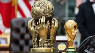 <p>GOLDEN BALLS: The FIFA 'Peace Prize', presented to US President Donald Trump at the 2025 World Cup Draw sits alongside the World Cup Trophy in the Oval Office of the White House in Washington, DC. Pic: Bonnie Cash/UPI/Bloomberg via Getty Images</p>