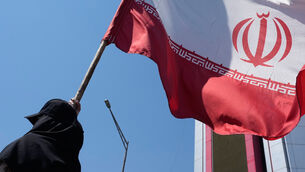 <p>A woman holds an Iranian flag during a pro-government campaign in downtown Tehran, Iran, Monday, June 8, 2026. (AP Photo/Vahid Salemi)</p>