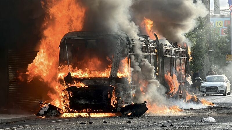 A Glider bus, set fire by protesters, on the Newtownards Road in east Belfast. Picture: PA Wire