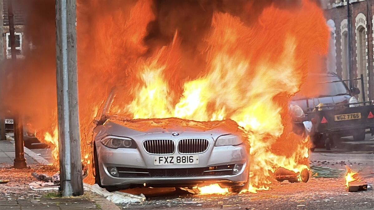 Vehicles set on fire by protesters on McMaster Street in east Belfast. Picture: PA/PA Wire