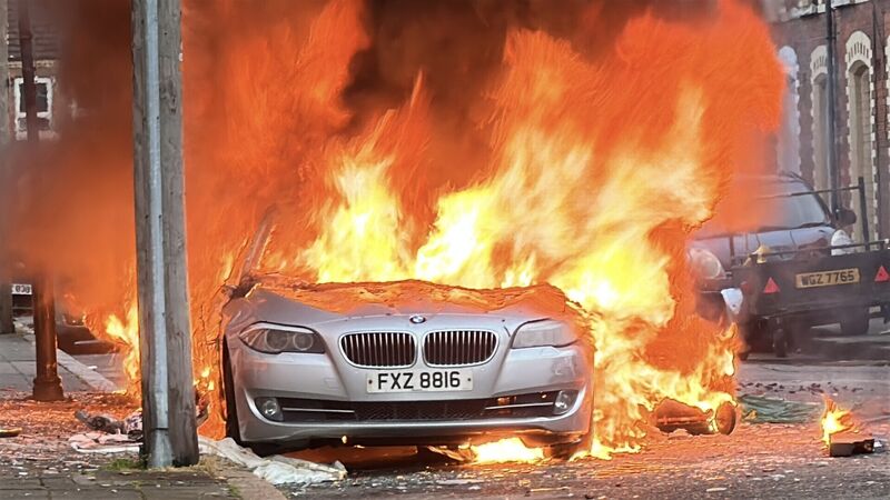 Vehicles set on fire by protesters on McMaster Street in east Belfast. Picture: PA/PA Wire