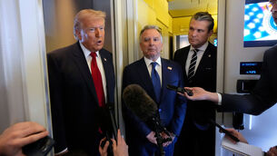 <p>President Donald Trump speaks to reporters as White House Special Envoy to the Middle East Steve Witkoff, center, and Defense Secretary Pete Hegseth listen while traveling aboard Air Force One. Picture: AP Photo/Mark Schiefelbein</p>