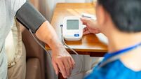 Doctor examine senior man patient at home.