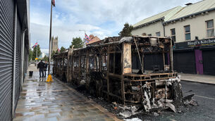 <p>A burned-out Glider bus on Newtownards Road in east Belfast after violence erupted on Tuesday (PA)</p>