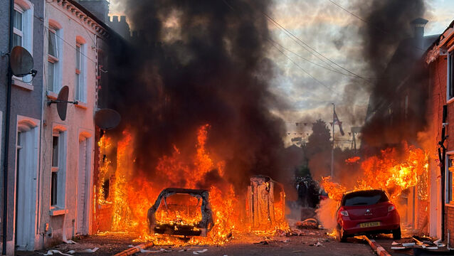 <p>Vehicles set on fire by protesters on Lendrick Street in Belfast as disorder flared in response to Monday night's stabbing attack in the city. Picture: PA</p>