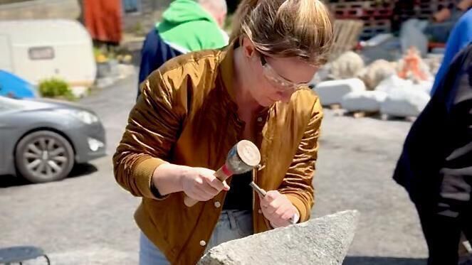 Jennifer gets 'in the zone' while stone carving. Jennifer gets 'in the zone' while stone carving.