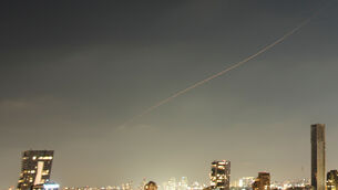 A projectile streaks through the sky over central Israel during an Iranian missile attack (Ohad Zwigenberg/AP)