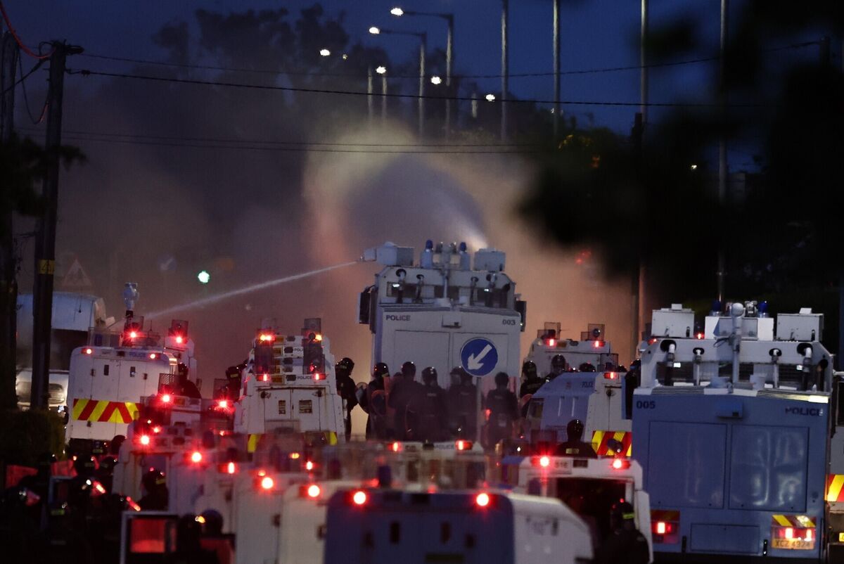 Police fire a water cannon towards rioters after they set fire to wheelie bins and removed a garden fence to use as a shield against the water cannon on Antrim Road, at the Sandyknowes roundabout in Newtownabbey. Picture date: Wednesday June 10, 2026. PA Photo. Photo credit should read: PA/PA Wire