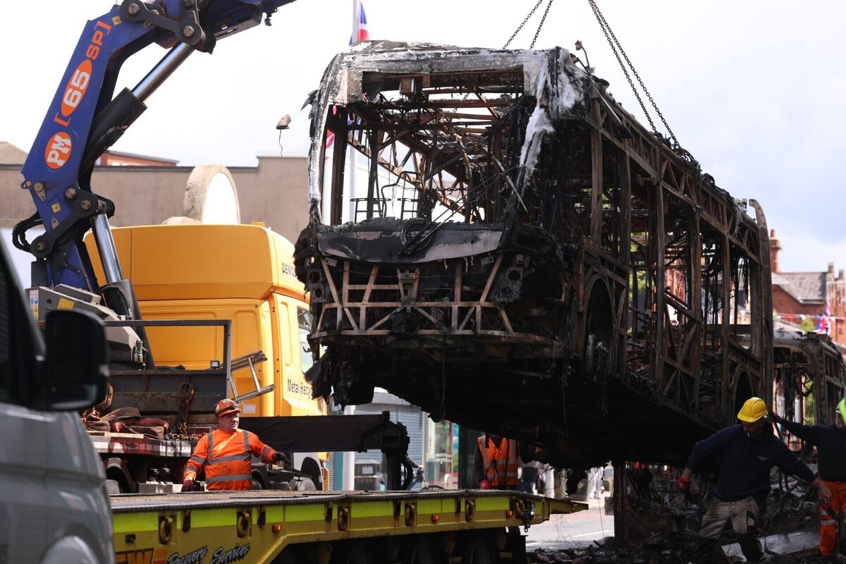 A Glider bus, on the Newtownards Road in east Belfast is removed, after it was set on fire during an anti-immigration demonstration organised in response to Monday night's stabbing attack in the city, leaving the victim with serious eye, face and back wounds. Picture: Liam McBurney/PA Wire