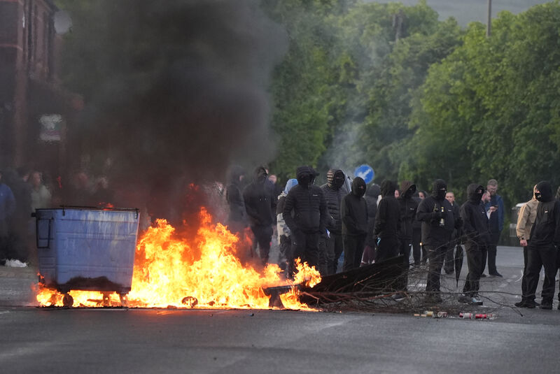 Bins set alight by protesters on Ligoniel Road, Belfast, as disorder flared during an anti-immigration demonstration organised in response to Monday night's stabbing attack in the city. Picture: PA Bins set alight by protesters on Ligoniel Road, Belfast, as disorder flared during an anti-immigration demonstration organised in response to Monday night's stabbing attack in the city. Picture: PA