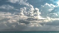 Beautiful Landscape depicting Strange Weather Phenomenon due to Climate Change, comprising dramatic dark grey Nimbus clouds alon