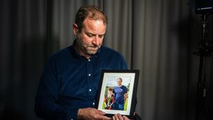 <p>Craig Coady holds a photograph of himself and Rory celebrating a sporting success. He said Rory’s memory gives him the strength to continue fighting for access to treatment for Paudie. Picture: Chani Anderson</p>