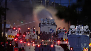 <p>Police fire a water cannon towards rioters after they set fire to wheelie bins and removed a garden fence to use as a shield against the water cannon on Antrim Road, at the Sandyknowes roundabout in Newtownabbey. Picture date: Wednesday June 10, 2026.</p>