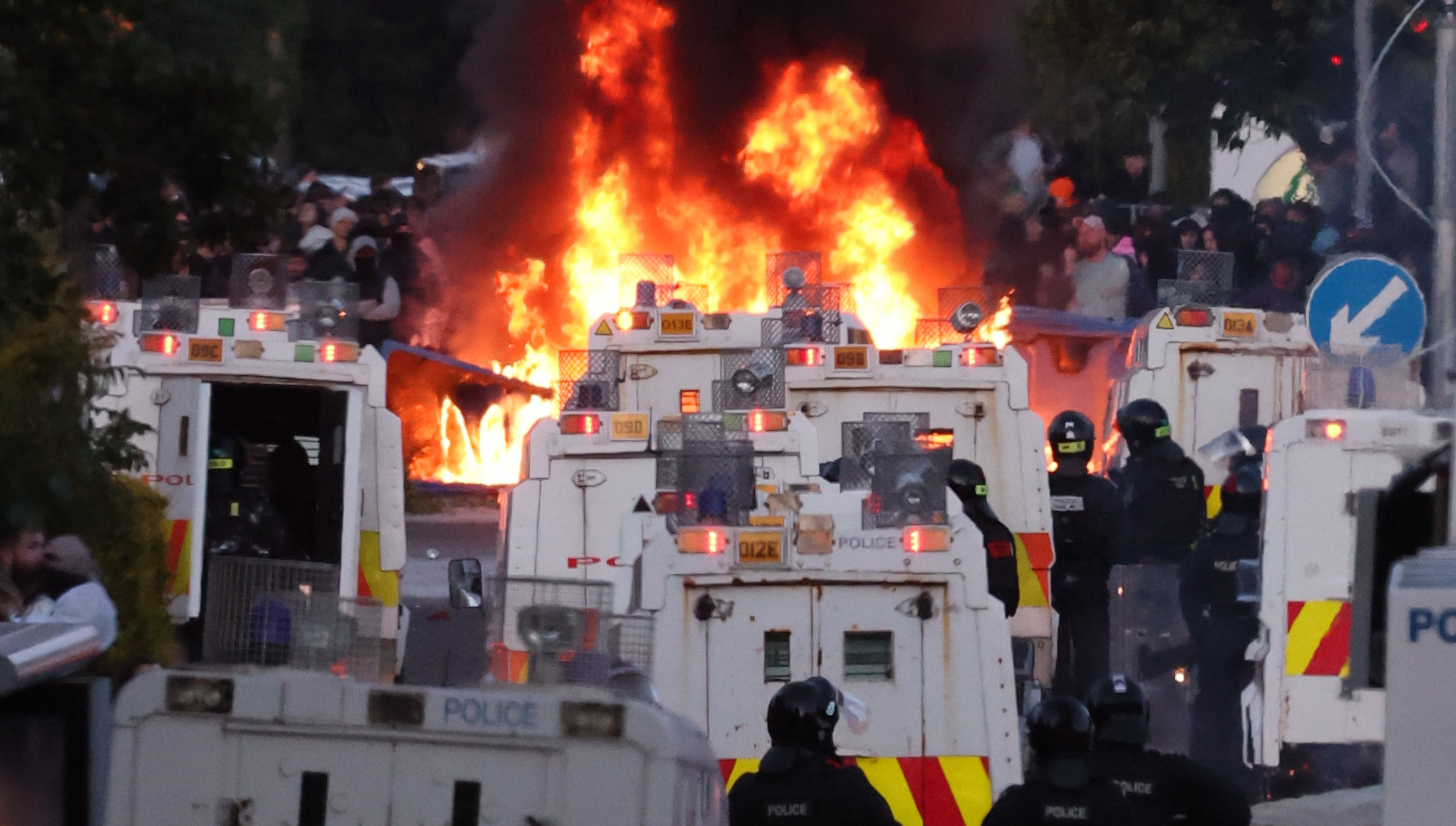 Protesters set fire to a barricade as police block Antrim Road, at the Sandyknowes roundabout in Newtownabbey. Picture: PA