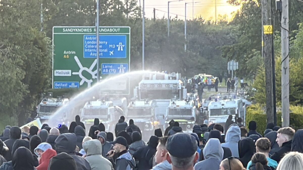 A water cannon is fired towards protesters on Antrim Road. Picture: PA A water cannon is fired towards protesters on Antrim Road. Picture: PA
