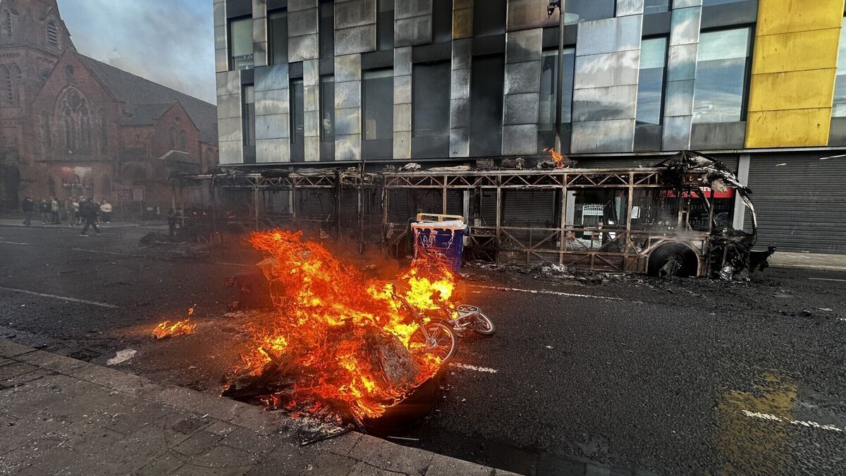 The skeleton of a Glider bus, set fire by protesters, on the Newtownards Road in east Belfast. Picture: PA The skeleton of a Glider bus, set fire by protesters, on the Newtownards Road in east Belfast. Picture: PA