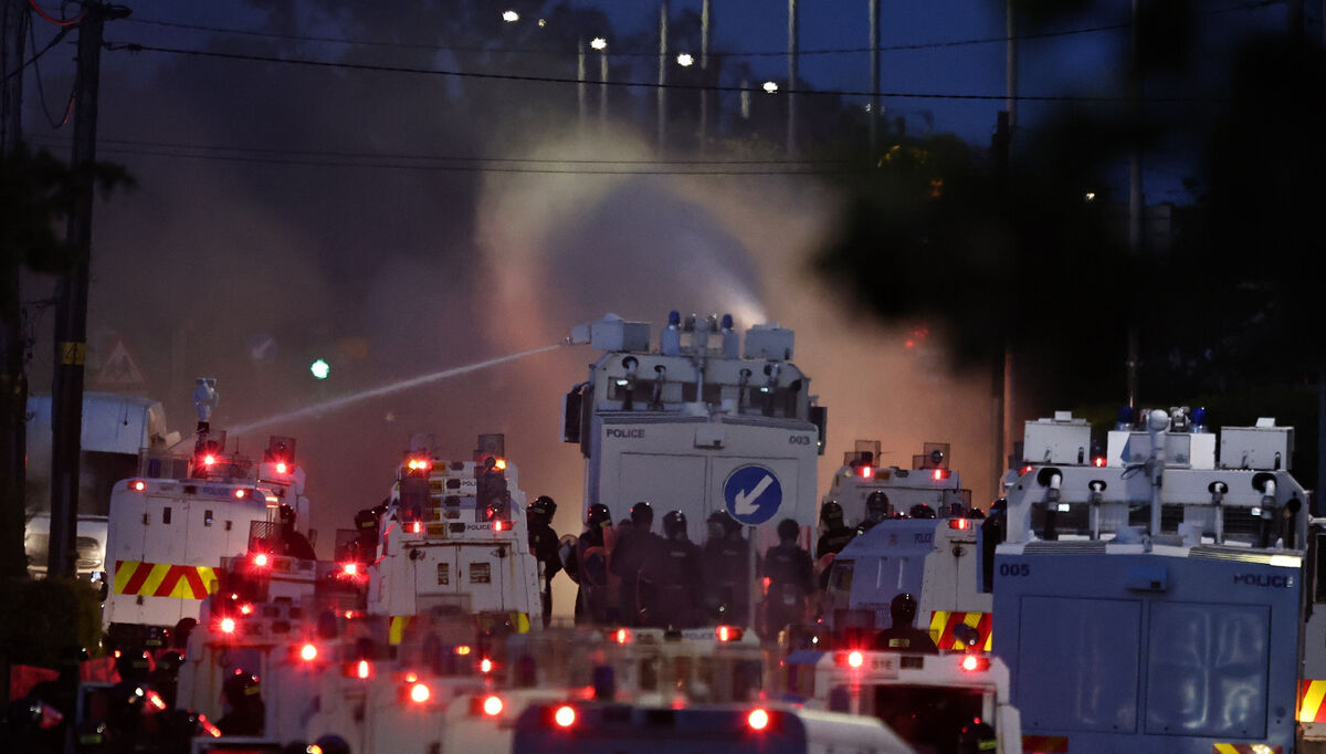 Police fire a water cannon towards rioters after they set fire to wheelie bins and removed a garden fence to use as a shield against the water cannon on Antrim Road, at the Sandyknowes roundabout in Newtownabbey on Wednesday. Picture: PA Police fire a water cannon towards rioters after they set fire to wheelie bins and removed a garden fence to use as a shield against the water cannon on Antrim Road, at the Sandyknowes roundabout in Newtownabbey on Wednesday. Picture: PA