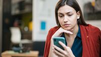 Close up of a sad young Caucasian woman reading bad news
