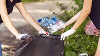 Woman hand picking up garbage plastic for cleaning at park