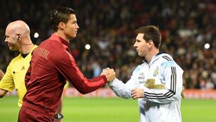 <p>TWO GREATS: Lionel Messi v Cristiano Ronaldo is a rivalry that, despite a lack of malice between the players, splits football down the middle. Pic: Martin Rickett/PA Wire.</p>