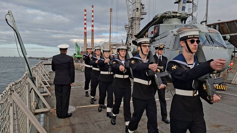 British sailors stand to attention at the conclusion of the ‘Sunset’ ceremony aboard HMS Somerset. Photo: Cormac O’Keeffe