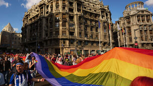 People walk carrying a rainbow flag during the pride parade in Bucharest, Romania (AAndreea Alexandru/AP) People walk carrying a rainbow flag during the pride parade in Bucharest, Romania (AAndreea Alexandru/AP)