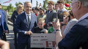 <p class="contextmenu internal_Caption">Canadian prime minister Mark Carney meets Jack Langan during his visit to Aughagower on Sunday. Picture: Andrew Downes/PA</p>