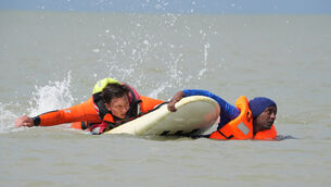 A member of the French fire service uses a buoyancy aid to rescue migrants (Gareth Fuller/PA) A member of the French fire service uses a buoyancy aid to rescue migrants (Gareth Fuller/PA)