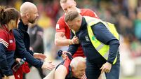 A steward tackles a Cork fan on the pitch after the game 13/6/2026