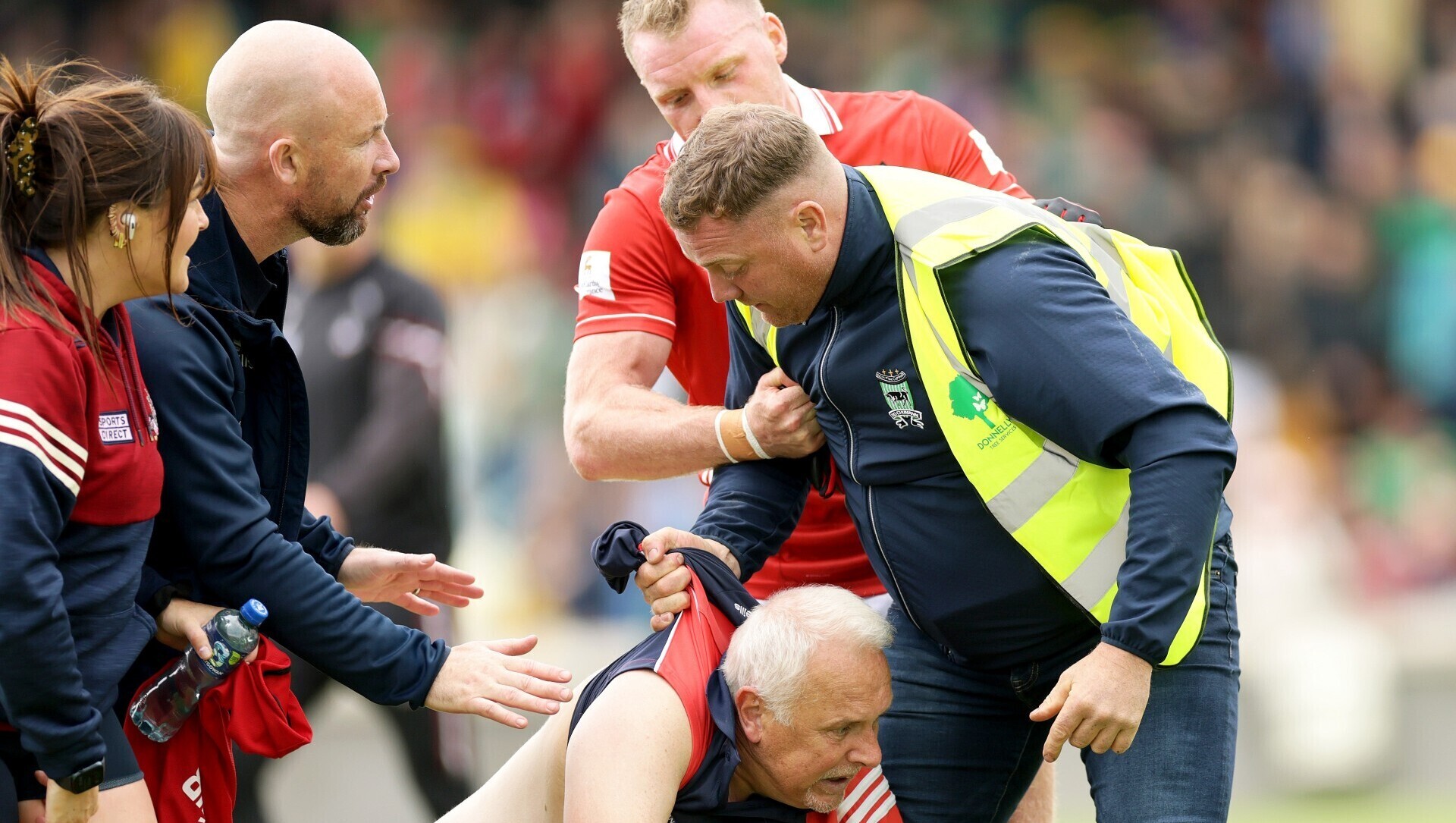 Cork GAA chief executive Kevin O’Donovan, physio Cliona O’Riordan and player Brian Hurley intervene as supporter Martin Lucey is restrained by a steward.. Pic: INPHO/Laszlo Geczo