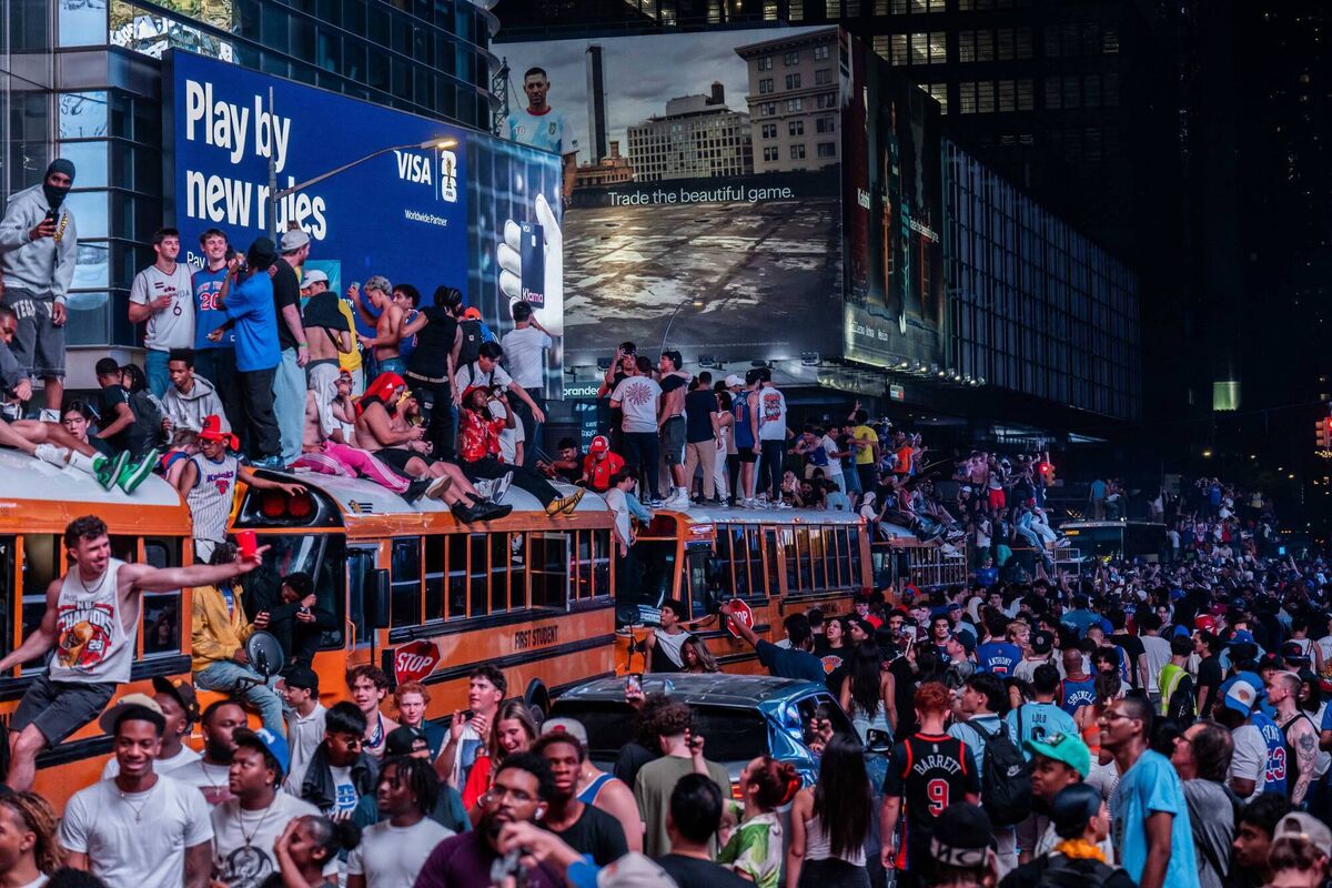 New York Knicks fans climb on buses as they celebrate their team beating the San Antonio Spurs in the NBA finals. Pic: Adam Gray/Getty Images New York Knicks fans climb on buses as they celebrate their team beating the San Antonio Spurs in the NBA finals. Pic: Adam Gray/Getty Images