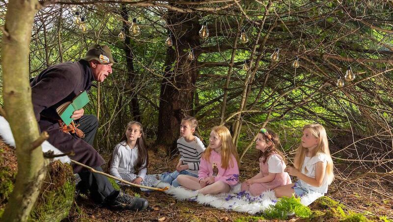 (Left to right) Bachelor In Trouble Tom Coffey performing a magical seanchaí session to Robyn Whelan, age 10, Tuireann Whelan, age 5, from Faha, sisters Erika Harrington, age 6, Klara Harrington, age 9 and Eva Whelan Kelleher, age 9, from Tramore deep in the Comeragh woodlands, as the full programme for Comeraghs Wild Festival 2026 was officially launched. Photo: Patrick Browne (Left to right) Bachelor In Trouble Tom Coffey performing a magical seanchaí session to Robyn Whelan, age 10, Tuireann Whelan, age 5, from Faha, sisters Erika Harrington, age 6, Klara Harrington, age 9 and Eva Whelan Kelleher, age 9, from Tramore deep in the Comeragh woodlands, as the full programme for Comeraghs Wild Festival 2026 was officially launched. Photo: Patrick Browne