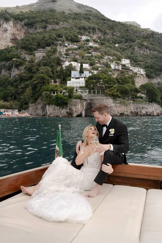 Aisling and Byron on a boat with Positano in the background. Aisling and Byron on a boat with Positano in the background.