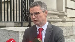 <p>Communications minister Patrick O’Donovan speaking to reporters outside Government Buildings in Dublin (Bairbre Holmes/PA)</p>