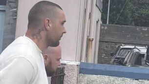 <p>Finnegan ‘Finn’ Yowell (33), with an address at Old School House, in Ticknock, County Waterford, pictured in a white tracksuit, was charged with the murder of Noreen Daly.</p> <p>Finnegan ‘Finn’ Yowell (33), with an address at Old School House, in Ticknock, County Waterford, pictured in a white tracksuit, was charged with the murder of Noreen Daly.</p>
