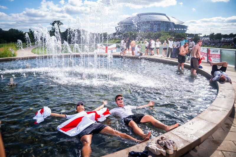 QUICK DIP: England fans lie in the fountain. Picture: James Manning/PA QUICK DIP: England fans lie in the fountain. Picture: James Manning/PA
