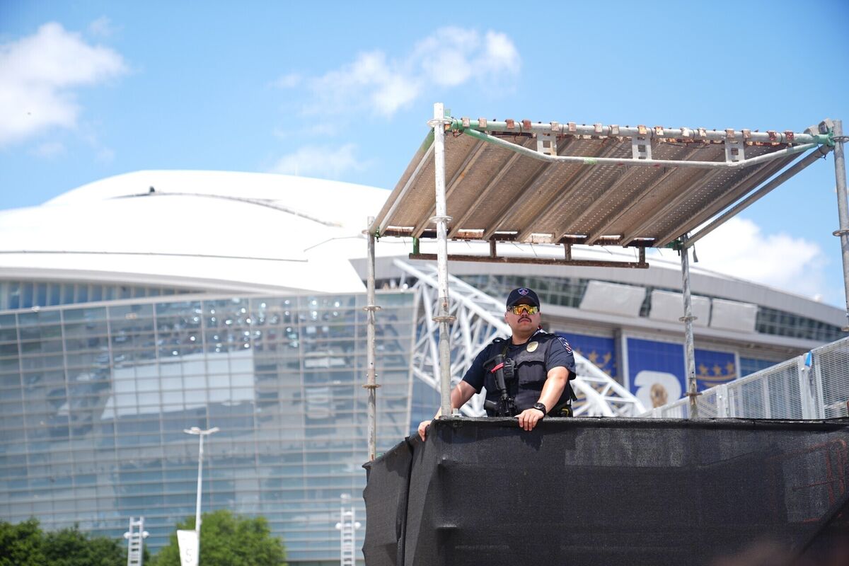 SECURE: A police officer observes from a watch tower as England and Croatia supporters arrive at the Dallas Stadium. Pic: James Manning/PA SECURE: A police officer observes from a watch tower as England and Croatia supporters arrive at the Dallas Stadium. Pic: James Manning/PA
