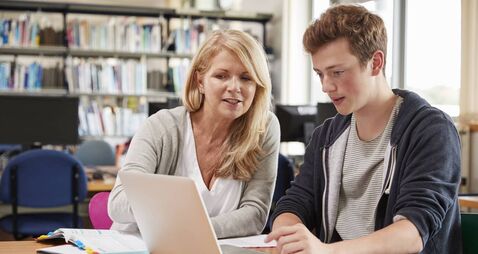 College Student Has Individual Tuition From Teacher In Library