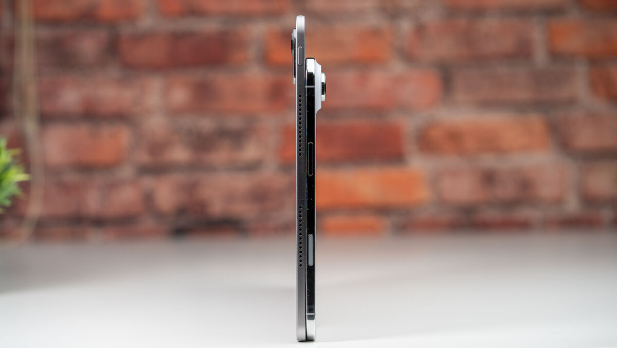 The 4.8mm thickness of the Honor MagicPad 4 highlights its slender build when placed beside the iPhone Air. Picture: Noel Campion
