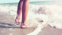 Jumping in the sea waves on the beach