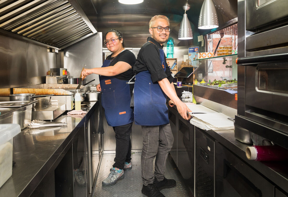 Monserrat Lopez and Nini Pham working in the Little Vietnam food truck following the announcement that food stalls would have to stop operating on Paul Street, Cork.