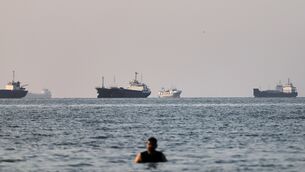 <p>A person stands on shallow water as cargo and commercial vessels are anchored in the Strait of Hormuz off Bandar Abbas, Iran, Monday, June 8, 2026. (Amirhosein Khorgooi/ISNA via AP)</p> <p>A person stands on shallow water as cargo and commercial vessels are anchored in the Strait of Hormuz off Bandar Abbas, Iran, Monday, June 8, 2026. (Amirhosein Khorgooi/ISNA via AP)</p>