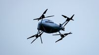 A Manna delivery drone flies over the ground during the match 3/5/2026