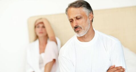 Unhappy man with woman in the background