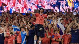 <p>SHIPPING UP TO BOSTON: Scotland fans celebratre victory over Haiti. Pic: Visionhaus/Getty Images)</p>