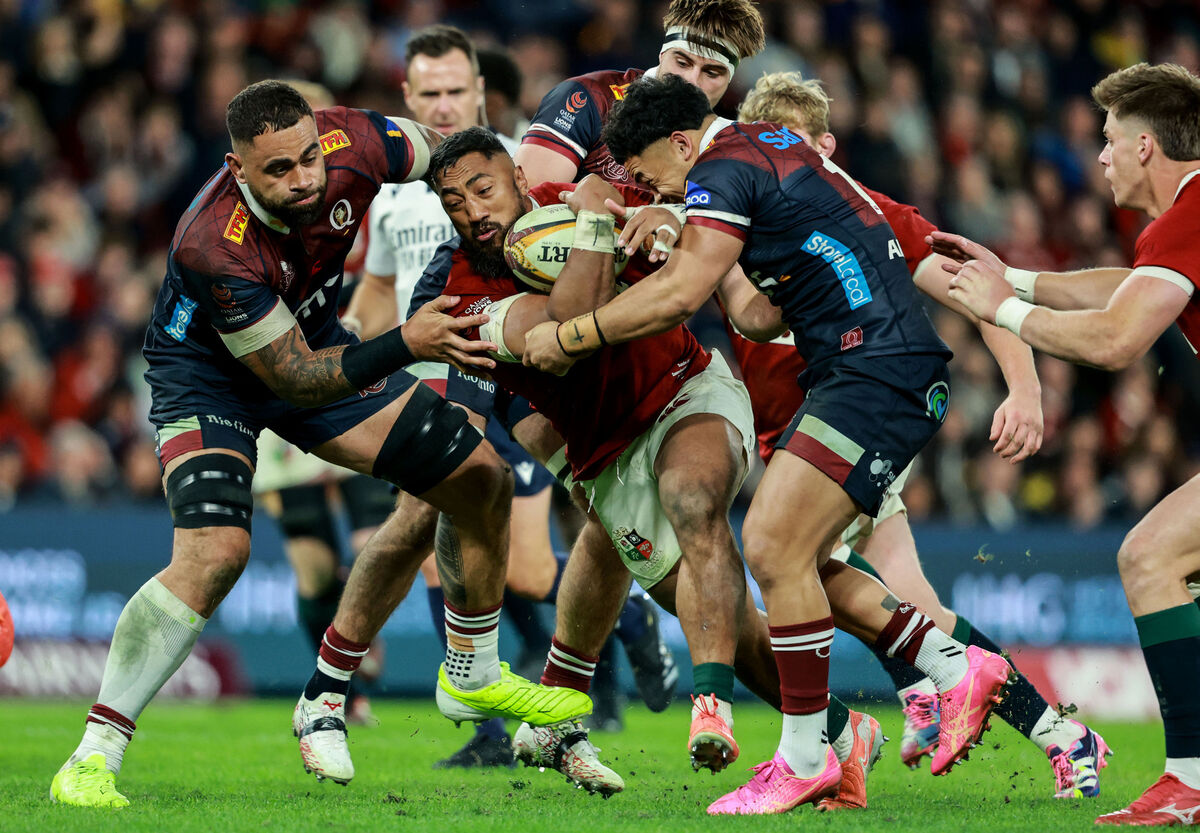Lions' Bundee Aki tackled by Lukhan Salakaia-Loto and Hunter Paisami of Queensland. Pic: Dan Sheridan