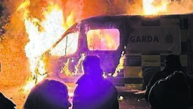 <p>A Garda van burns in a protest last year that was promoted by far-right groups. Picture: Sasko Lazarov</p>